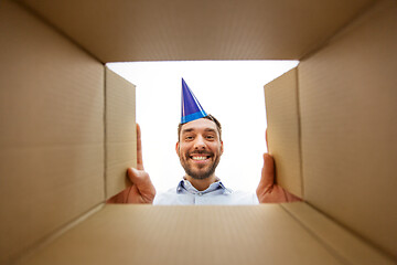 Image showing happy man opening parcel box or birthday gift