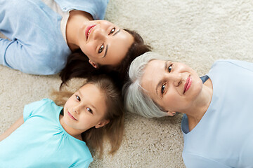 Image showing mother, daughter and grandmother lying on floor