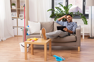 Image showing man with tablet computer after home cleaning