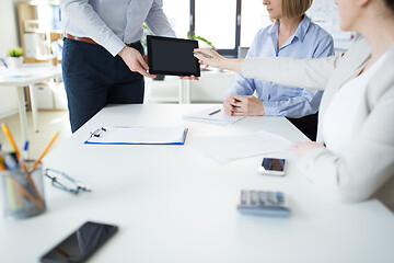 Image showing close up of business team with tablet pc at office