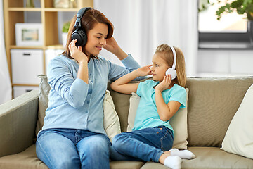 Image showing mother and daughter in headphones listen to music
