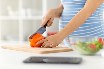 Image showing pregnant woman cooking vegetable salad at home