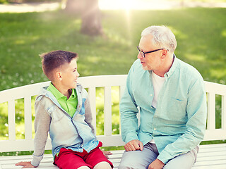 Image showing grandfather and grandson talking at summer park