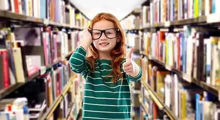 Image showing smiling red haired girl in glasses at library