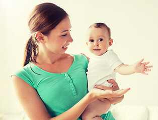 Image showing happy young mother with little baby at home