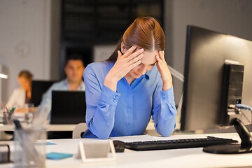 Image showing businesswoman with computer at night office