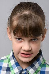 Image showing Portrait of an angry grin ten-year-old girl of European appearance, close-up