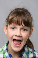 Image showing Portrait of a happy ten year old girl with wide mouth, European appearance, close-up