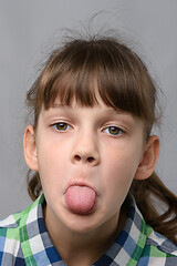 Image showing Portrait of a ten-year-old girl who shows offended language, European appearance, close-up