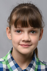 Image showing Portrait of a happy ten year old girl of European appearance, close-up