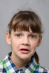 Image showing Portrait of a puzzled ten-year-old girl of European appearance, close-up