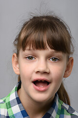 Image showing Portrait of a funny ten-year-old girl with wide mouth, European appearance, close-up