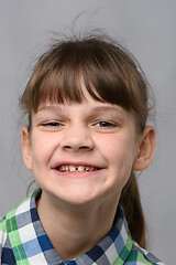 Image showing Portrait of a funny smiling ten-year-old girl of European appearance, close-up