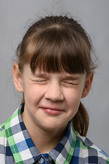 Image showing Portrait of a ten-year-old girl who closed her eyes, European appearance, close-up