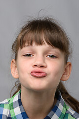 Image showing Portrait of a ten-year-old girl showing a kiss, European appearance, close-up