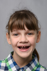 Image showing Portrait of a funny ten-year-old girl with a cheerful smile, European appearance, close-up