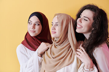 Image showing muslim women in fashionable dress isolated on yellow