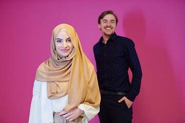 Image showing portrait of young muslim couple isolated on pink background