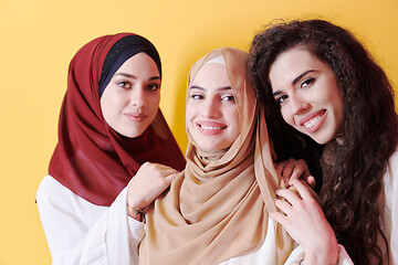 Image showing muslim women in fashionable dress isolated on yellow