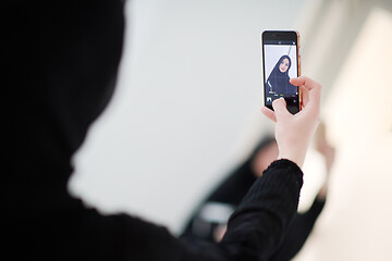 Image showing muslim woman taking selfie picture at home