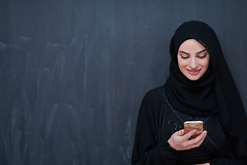 Image showing young modern muslim business woman using smartphone