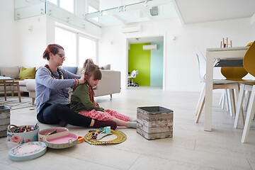 Image showing Mother and little girl daughter playing with jewelry  at home