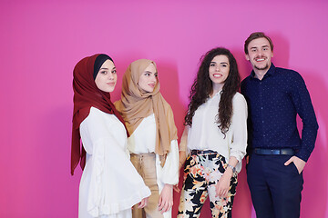 Image showing group portrait of young muslim people isolated on pink