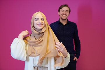 Image showing portrait of young muslim couple isolated on pink background