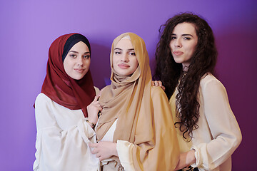 Image showing muslim women in fashionable dress isolated on purple