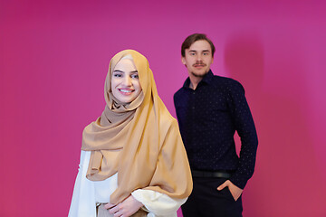 Image showing portrait of young muslim couple isolated on pink background