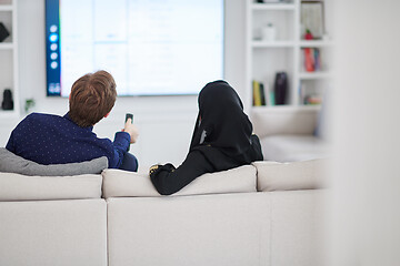 Image showing young muslim couple watching TV together