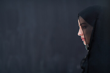 Image showing portrait of beautiful muslim woman in front of black chalkboard