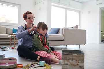 Image showing Mother and little girl daughter playing with jewelry  at home