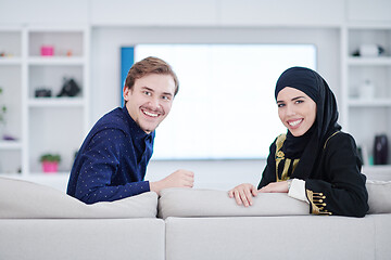 Image showing young muslim couple watching TV together