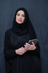 Image showing young modern muslim business woman using tablet computer