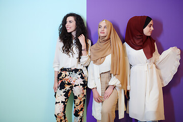 Image showing muslim women in fashionable dress isolated on colorful backgroun