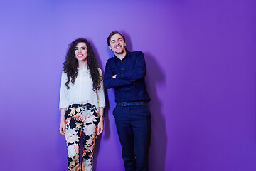 Image showing portrait of young couple isolated over purple background