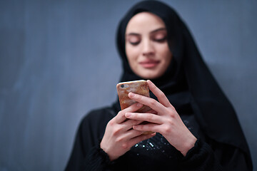 Image showing young modern muslim business woman using smartphone