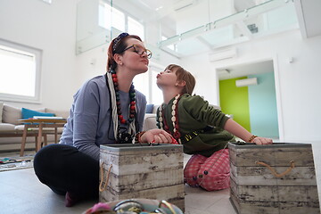 Image showing Mother and little girl daughter playing with jewelry  at home