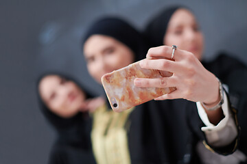 Image showing muslim women taking selfie picture in front of black chalkboard