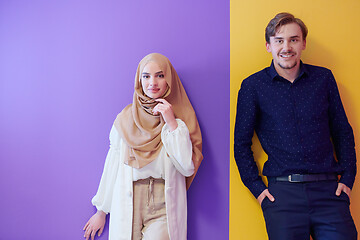 Image showing portrait of young muslim couple isolated on colorful background