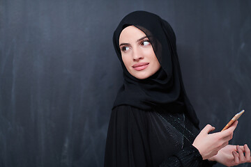 Image showing young modern muslim business woman using smartphone