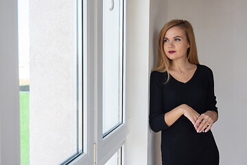 Image showing Beautiful girl looks in a new apartment in a new building