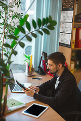 Image showing Caucasian entrepreneur, businessman, manager working concentrated in office