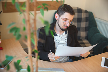 Image showing Caucasian entrepreneur, businessman, manager working concentrated in office