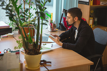 Image showing Caucasian entrepreneur, businessman, manager working concentrated in office