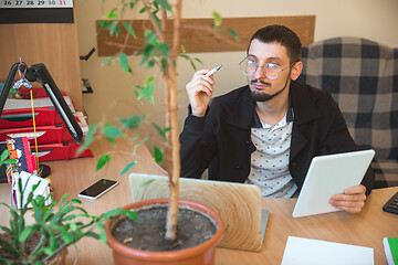 Image showing Caucasian entrepreneur, businessman, manager working concentrated in office