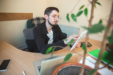 Image showing Caucasian entrepreneur, businessman, manager working concentrated in office