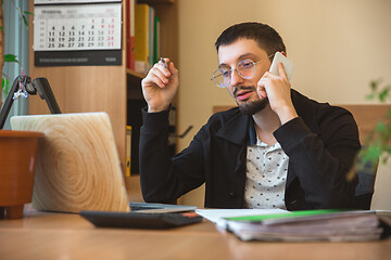 Image showing Caucasian entrepreneur, businessman, manager working concentrated in office