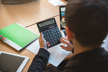 Image showing Caucasian entrepreneur, businessman, manager working concentrated in office